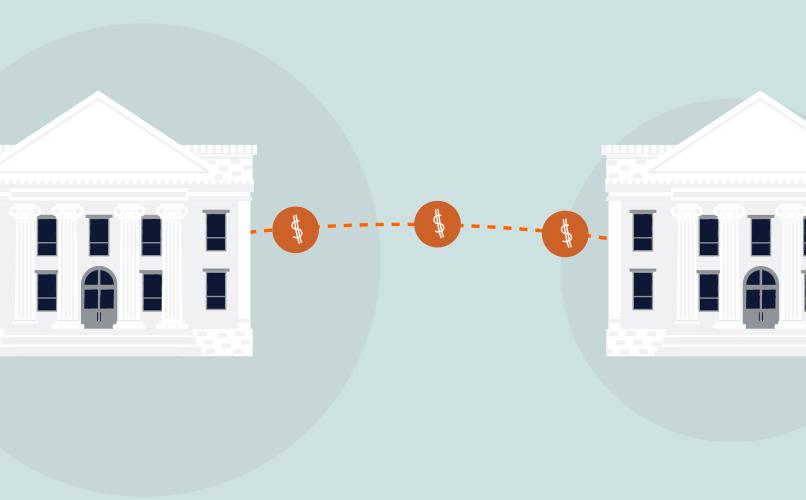 Illustration of two white classical buildings with columns, connected by a dotted line with dollar signs, symbolizing a bank deposit or financial transfer between the structures. The background is light blue.